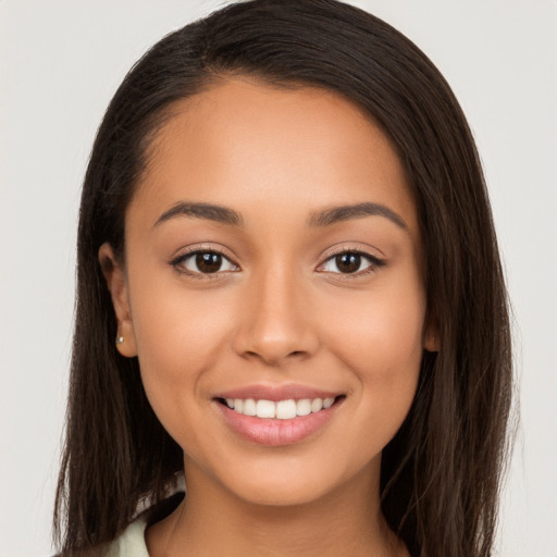 Joyful white young-adult female with long  brown hair and brown eyes