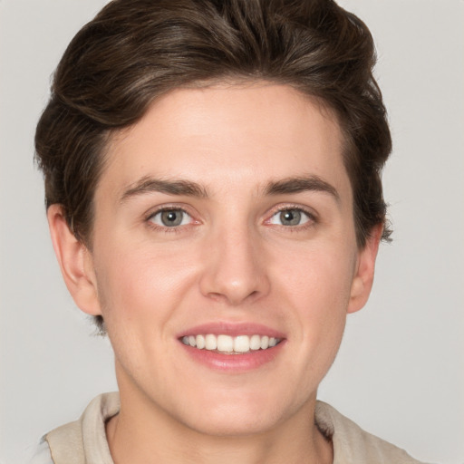 Joyful white young-adult female with short  brown hair and grey eyes