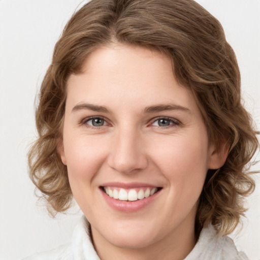 Joyful white young-adult female with medium  brown hair and green eyes