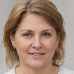 Joyful white adult female with medium  brown hair and brown eyes