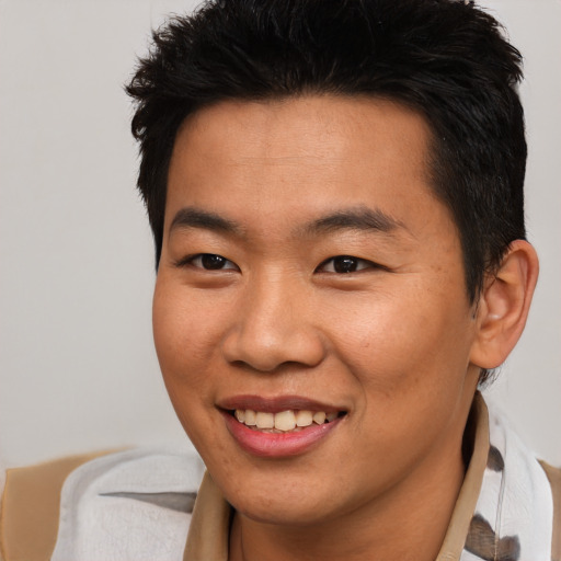 Joyful asian young-adult male with short  brown hair and brown eyes