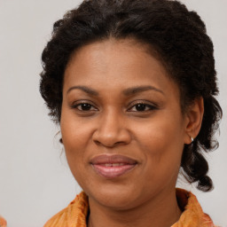 Joyful black adult female with medium  brown hair and brown eyes