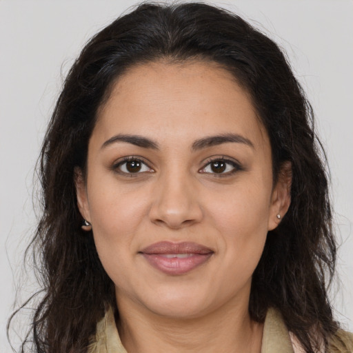 Joyful latino young-adult female with long  brown hair and brown eyes