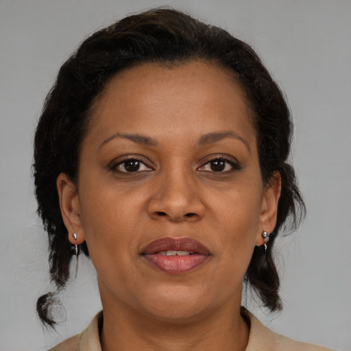 Joyful black adult female with medium  brown hair and brown eyes