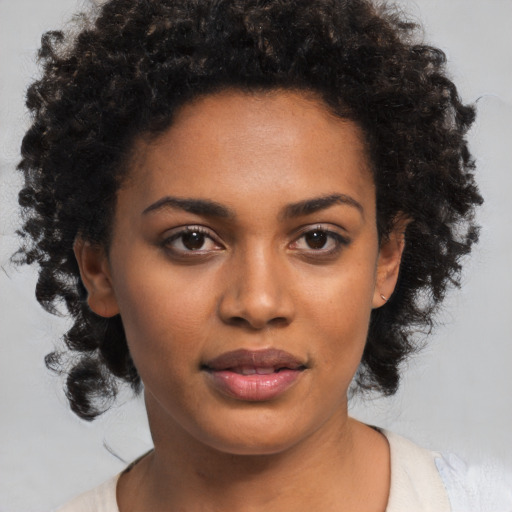 Joyful black young-adult female with medium  brown hair and brown eyes