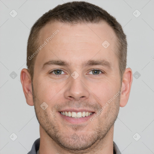 Joyful white young-adult male with short  brown hair and grey eyes