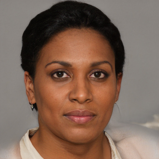 Joyful black adult female with short  brown hair and brown eyes