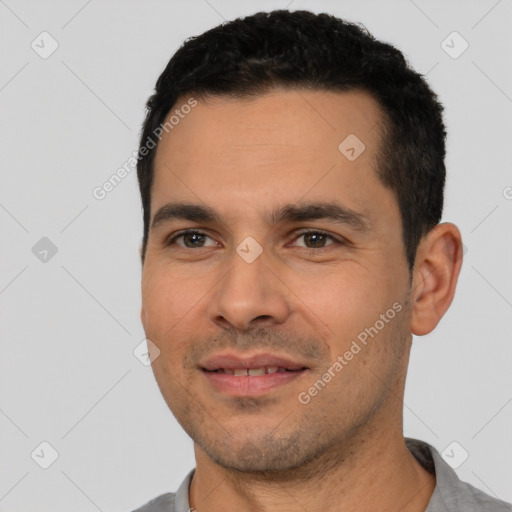 Joyful white young-adult male with short  black hair and brown eyes