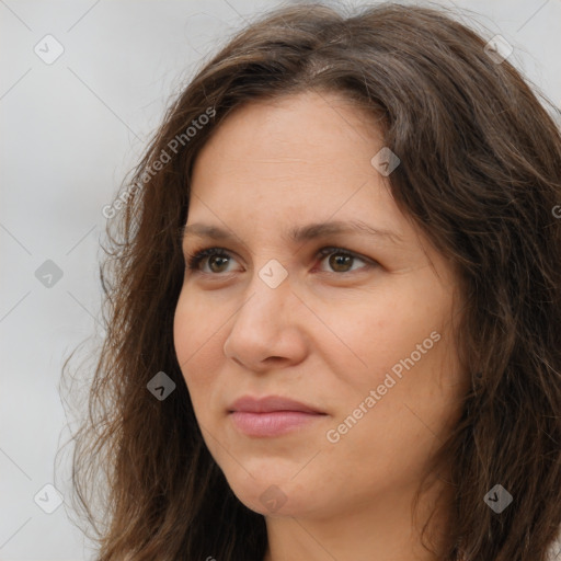 Joyful white adult female with long  brown hair and brown eyes