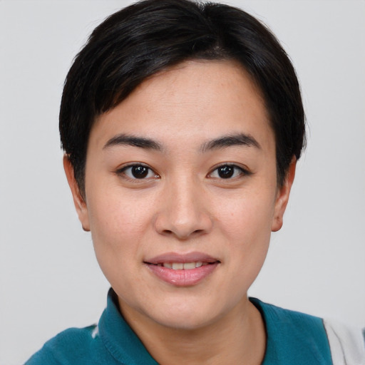 Joyful asian young-adult female with short  brown hair and brown eyes