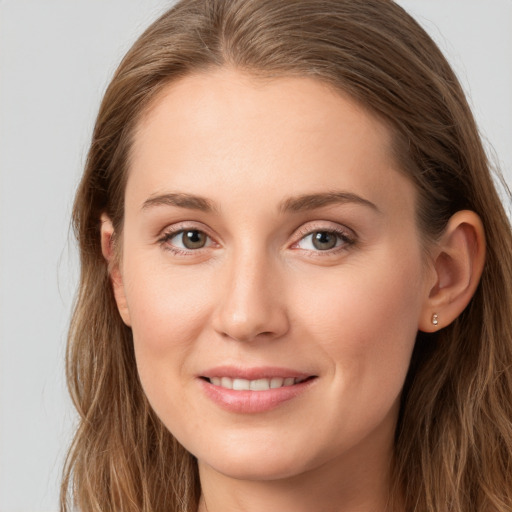 Joyful white young-adult female with long  brown hair and grey eyes