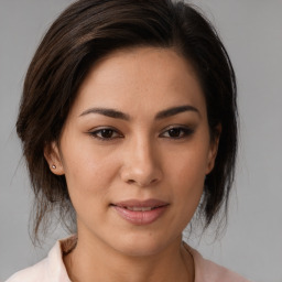 Joyful asian young-adult female with medium  brown hair and brown eyes