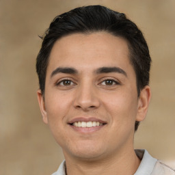 Joyful white young-adult male with short  black hair and brown eyes