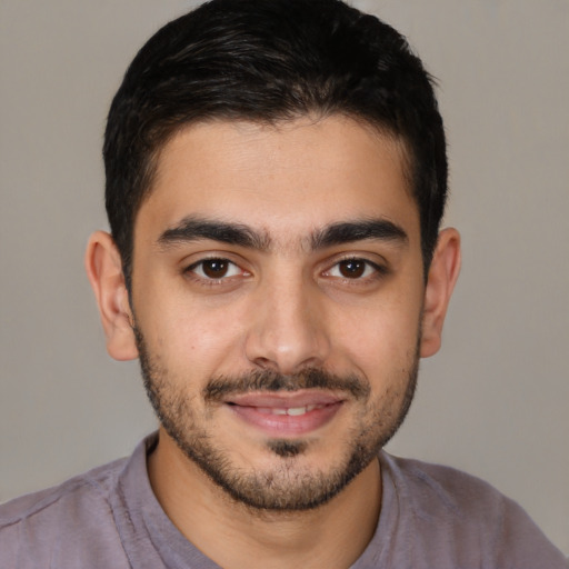 Joyful latino young-adult male with short  brown hair and brown eyes