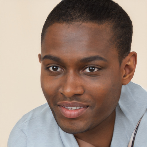 Joyful black young-adult male with short  brown hair and brown eyes