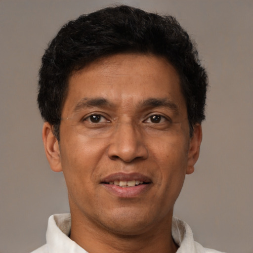Joyful asian adult male with short  brown hair and brown eyes