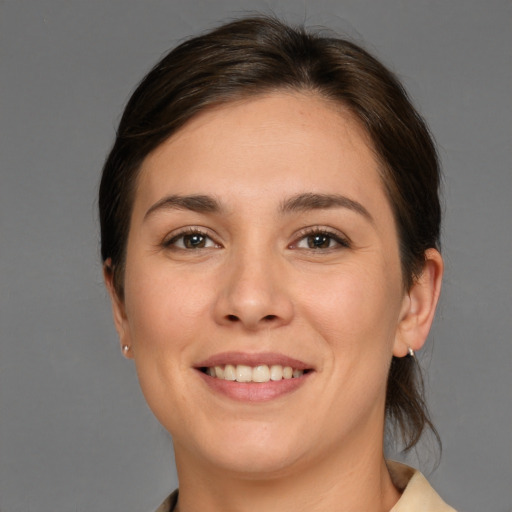 Joyful white young-adult female with medium  brown hair and brown eyes