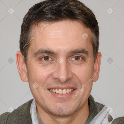 Joyful white adult male with short  brown hair and brown eyes