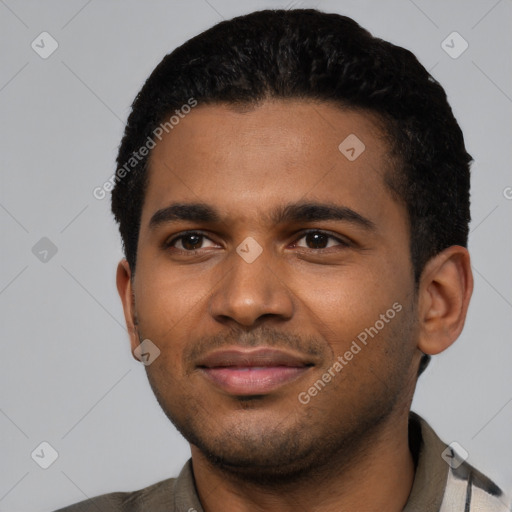 Joyful black young-adult male with short  black hair and brown eyes