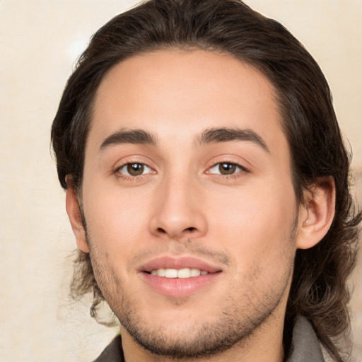 Joyful white young-adult male with medium  brown hair and brown eyes