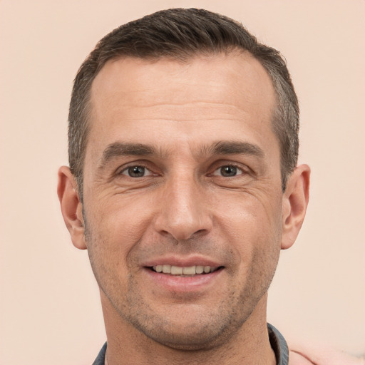 Joyful white adult male with short  brown hair and brown eyes