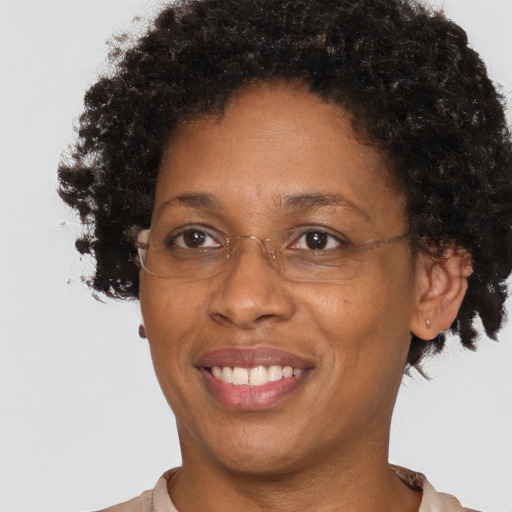 Joyful black adult female with short  brown hair and brown eyes