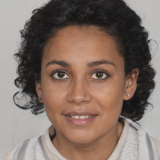Joyful black young-adult female with medium  brown hair and brown eyes