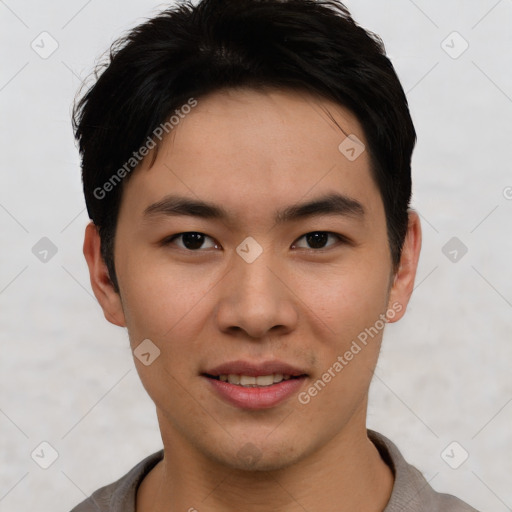 Joyful asian young-adult male with short  black hair and brown eyes