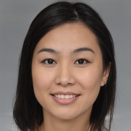 Joyful asian young-adult female with medium  brown hair and brown eyes