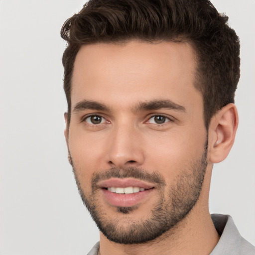 Joyful white young-adult male with short  brown hair and brown eyes