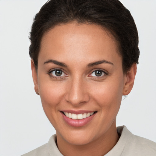 Joyful white young-adult female with short  brown hair and brown eyes