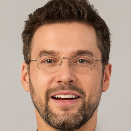 Joyful white adult male with short  brown hair and brown eyes