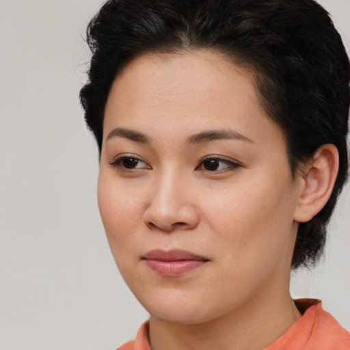 Joyful asian young-adult female with short  brown hair and brown eyes