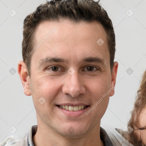 Joyful white adult male with short  brown hair and brown eyes