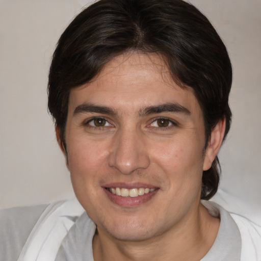 Joyful white young-adult male with medium  brown hair and brown eyes