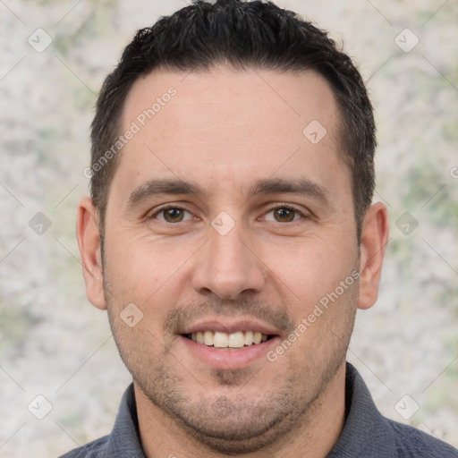 Joyful white adult male with short  brown hair and brown eyes