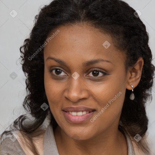 Joyful black young-adult female with long  brown hair and brown eyes