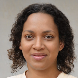 Joyful black young-adult female with medium  brown hair and brown eyes