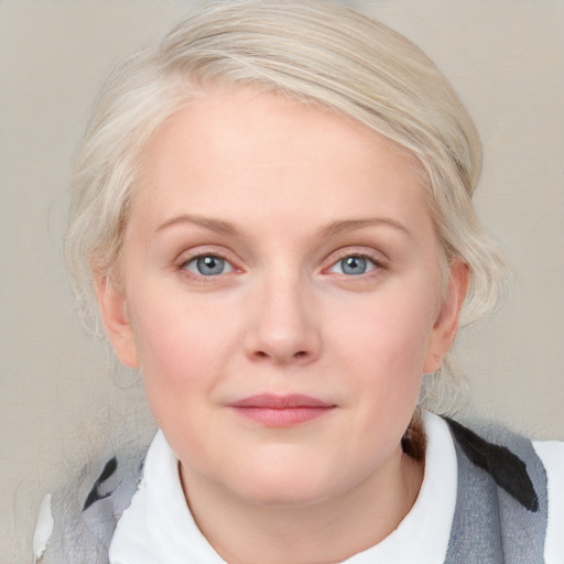 Joyful white young-adult female with medium  blond hair and blue eyes