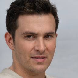 Joyful white adult male with short  brown hair and brown eyes