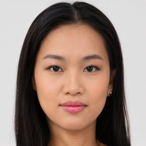 Joyful asian young-adult female with long  brown hair and brown eyes
