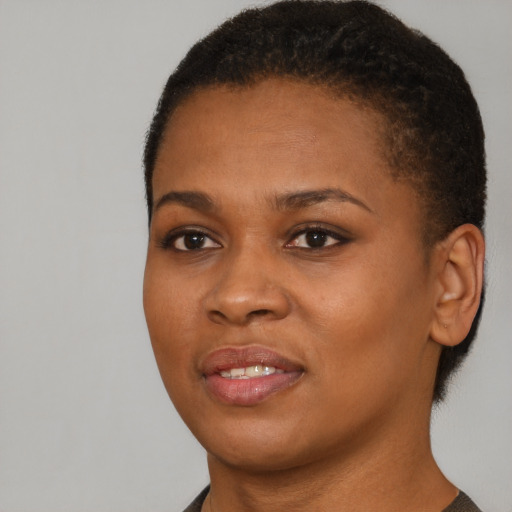 Joyful black young-adult female with short  brown hair and brown eyes