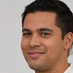 Joyful white young-adult male with short  black hair and brown eyes