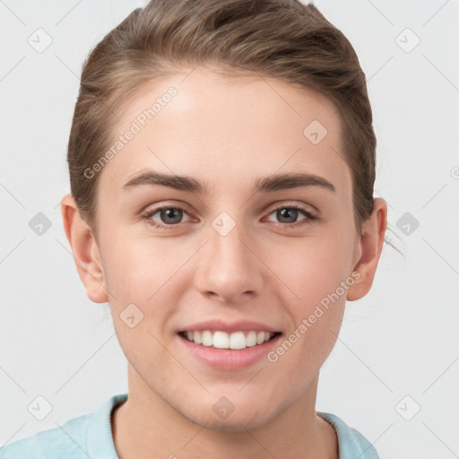 Joyful white young-adult female with short  brown hair and grey eyes