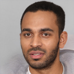 Joyful latino young-adult male with short  black hair and brown eyes