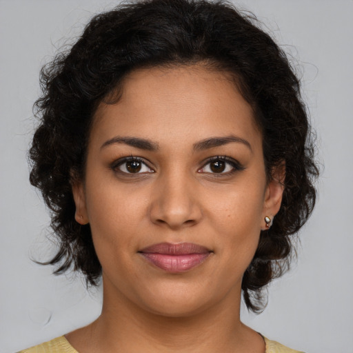 Joyful latino young-adult female with medium  brown hair and brown eyes