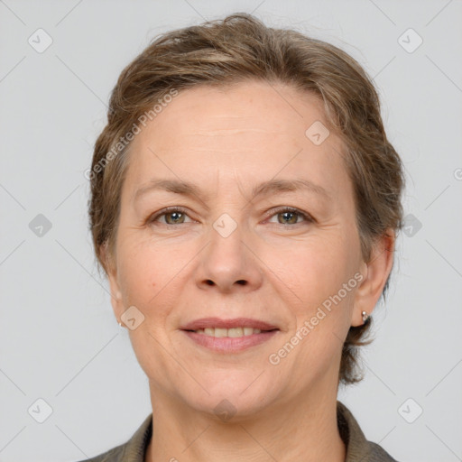 Joyful white adult female with medium  brown hair and grey eyes