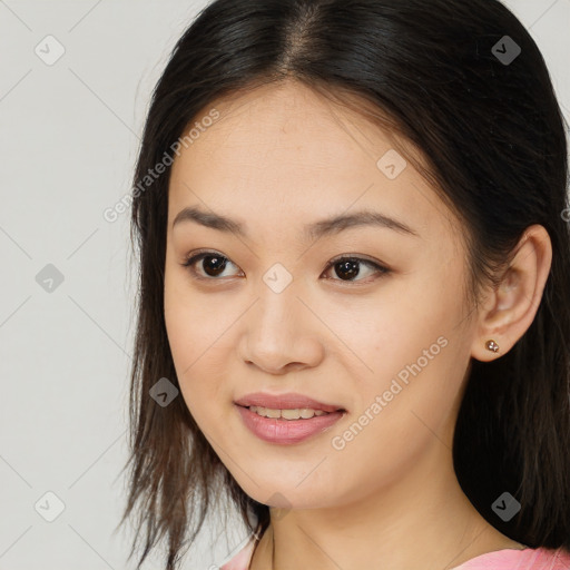 Joyful asian young-adult female with long  brown hair and brown eyes