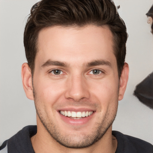 Joyful white young-adult male with short  brown hair and grey eyes