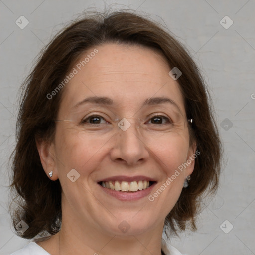 Joyful white adult female with medium  brown hair and brown eyes